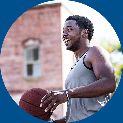 Man in red shirt holding basketball